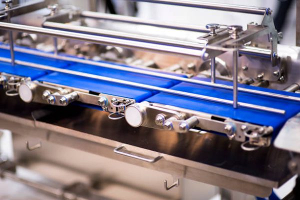 pharmaceutical packing production line conveyer at manufacture pharmacy factory. Authentic shot in challenging conditions. maybe little blurred.